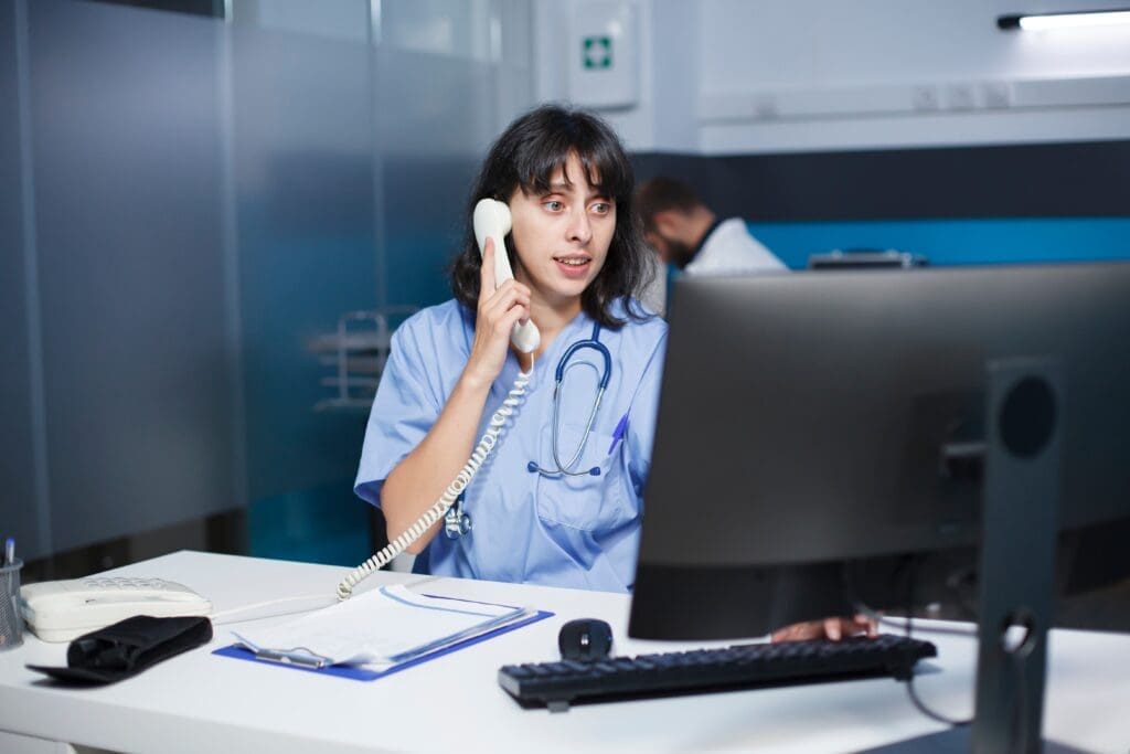 Healthcare workers using a VoIP system to manage patient communications in a clinical setting.