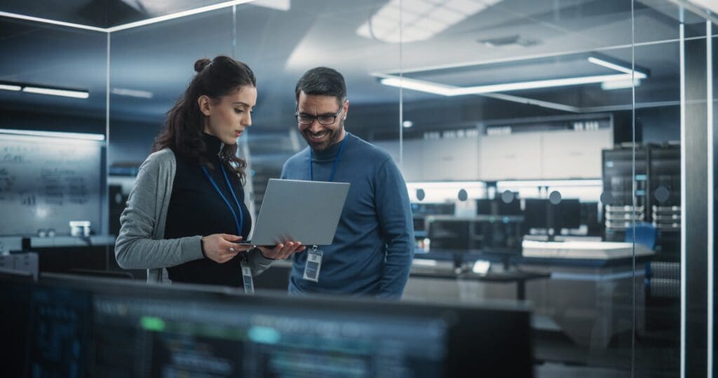 Portrait,Of,Two,Happy,Female,And,Male,Engineers,Using,Laptop